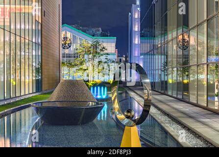 tokyo, japan - december 01 2020: Modern art objects and fountain in the inner garden of Shinjuku Lumine building between the glassed facades of the NE Stock Photo