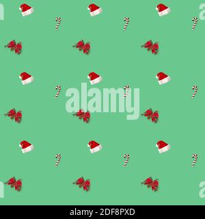 seamless pattern Santa hat, bow and candy cane candy cane on green background Stock Photo