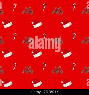 seamless pattern Santa hat and candy cane candy cane on red background Stock Photo