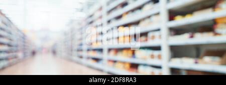 Food market interior. Blur corridor background. Shop shelf. Stock goods. Stock Photo