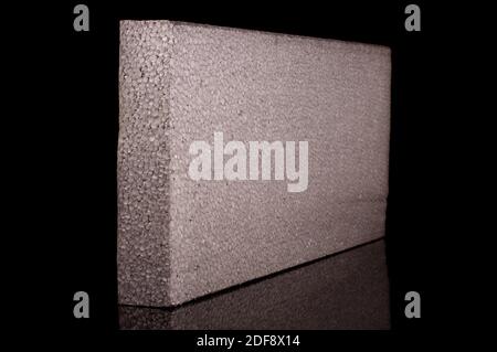 Block of thermal insulation with graphite polystyrene for thermal insulation of house walls isolated on the black background Stock Photo