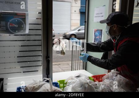 The association 'L Armee du Salut' prepares and distributes more than 600 meals for underprivileged people. Normally the meals take place inside the building, but due to the Covid-19 epidemic people take their meals and eat outside. Paris, France, April 3, 2020. Photo by Florent Bardos/ABACAPRESS.COM Stock Photo