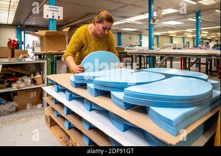 Employees Manipulate Plastic Face Shields To Be Used As Protection Against Covid 19 In Factory In