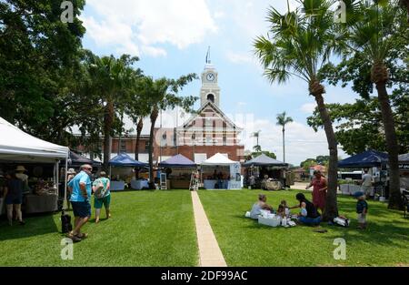 People relaxing in a park by the City Hall in Kent Street on a sunny day, Maryborough, Sunshine Coast, Queensland, QLD, Australia Stock Photo