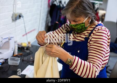 Volunteers, wearing home made face mask protection against the coronavirus, of the Simplon.co fab lab makes medical blouse by hand and sewing machines for the hospitals in Paris and the Region ile de France. Paris, April 27 2020. Photo by Raphael Lafargue/ABACAPRESS.COM Stock Photo