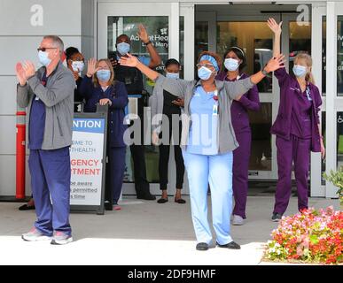 NO FILM, NO VIDEO, NO TV, NO DOCUMENTARY - Medical workers cheer as police, fire and rescue agencies arrive at AdventHealth Lake Mary during a 'Heroes Thanking Heroes' parade, Wednesday, April 29, 2020 in Sanford, FL, USA. First responders from Sanford, Lake Mary, Longwood, Altamonte Springs and Seminole County caravanned to thank the workers during visits to Central Florida Regional Hospital, AdventHealth Lake Mary and Orlando Health Lake Mary. Photo by Joe Burbank/Orlando Sentinel/TNS/ABACAPRESS.COM Stock Photo