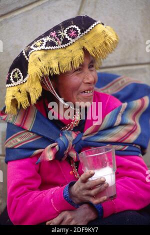 QUECHUA woman drinks the local brew in a rural town near our destination of AUZANGATE - PERU Stock Photo