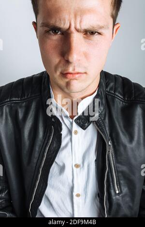 The guy in the Studio. The guy in the black jacket. Handsome guy. High quality photo Stock Photo