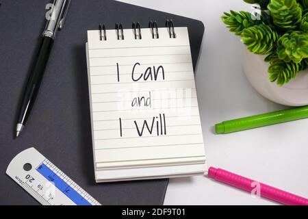 Notebook with wisdom quote on top of office desk. Stock Photo