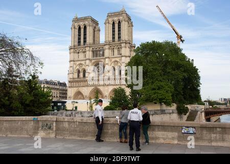 Police forces control people in the street in front of the Notre Dame Cathedral in Paris on May 7, 2020, during a strict lockdown in France, in place to attempt to stop the spread of the new coronavirus (COVID-19). Photo by Raphael Lafargue/ABACAPRESS.COM Stock Photo
