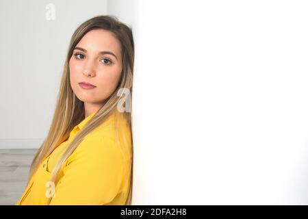 Portrait of a serious young woman in front of white background Stock Photo