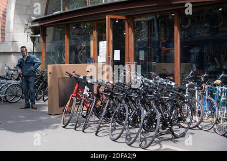 Clients and staff members are seen at the Bicloune bicycle shop in