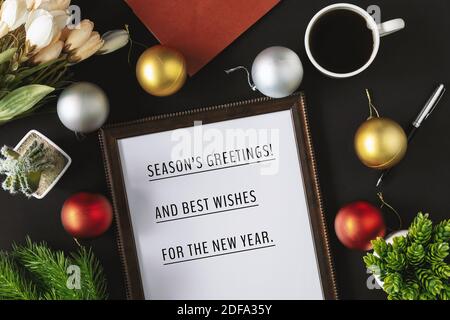 Wood frame with season's greetings wish and ornament balls decoration. Merry Christmas and holiday concepts. Stock Photo