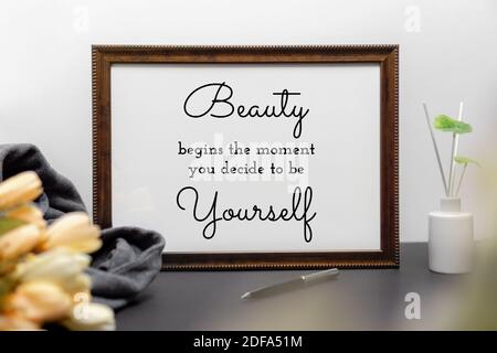 Inspirational and motivation beauty and life quote on wood frame - Beauty Begins the Moment You Decide to be Yourself. Stock Photo