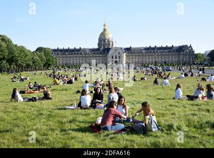 People sit on the grass at the Invalides in Paris on May 17, 2020, on the first weekend after France eased lockdown measures taken to curb the spread of the COVID-19 pandemic, caused by the novel coronavirus. Photo by Alain Apaydin/ABACAPRESS.COM Stock Photo