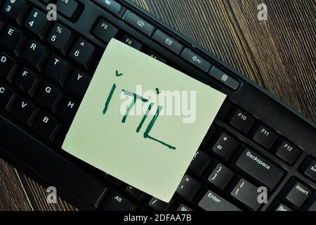 ITIL write on sticky notes isolated on Wooden Table. Stock Photo