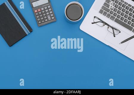Overhead View of Laptop, Notebook and Calculator on Work Desk Stock Photo