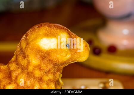 preparation of treats for traditional Orthodox Christmas - handmade baked cookies in the form of lambkin on a wooden table Stock Photo