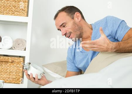 upset man waking up in the morning light Stock Photo