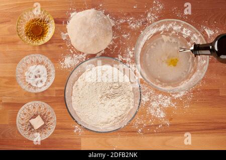Making italian pizza step by step with ingredients for hand made dough: adding olive oil Stock Photo