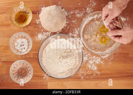 Making italian pizza step by step with ingredients for hand made dough: adding yeast Stock Photo