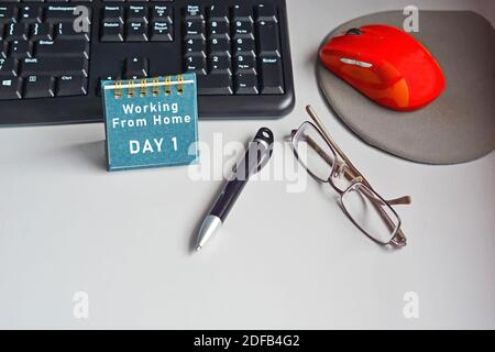 Home desk with keyboard, mouse, eyeglasses, pen and calendar with text Stock Photo