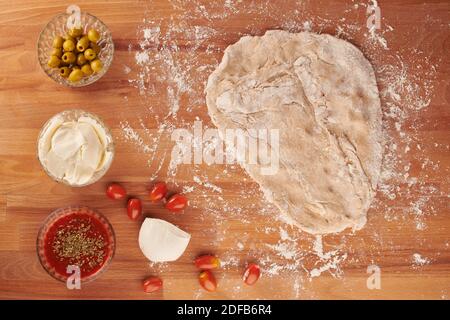 Making italian pizza step by step with ingredients for hand made pizza: pizza dough rolled out Stock Photo