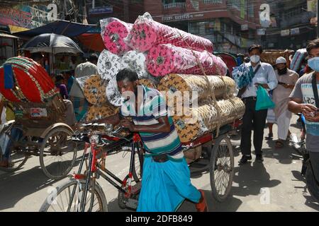 A Bangladeshi rickshaw van puller works during hot summer day without taking any safety measures in Dhaka, Bangladesh, June 25, 2020. Photo by Kanti Das Suvra/ABACAPRESS.COM Stock Photo