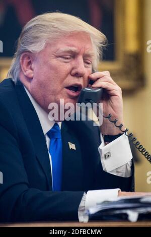 File photo dated January 28, 2017 of President Donald Trump speaks on the phone with Prime Minister of Australia, Malcolm Turnbull in the Oval Office in Washington, DC, USA. In hundreds of highly classified phone calls with foreign heads of state, President Donald Trump was so consistently unprepared for discussion of serious issues, so often outplayed in his conversations with powerful leaders like Russian President Vladimir Putin and Turkish President Recep Erdogan, and so abusive to leaders of America's principal allies, that the calls helped convince some senior US officials that the Presi Stock Photo