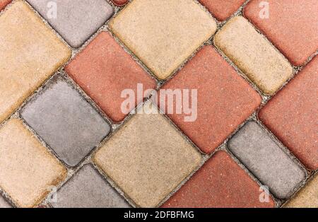 Beautiful coloured tiles in the yard. Tiles in the garden. Paving slabs Stock Photo