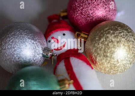 White snowman in a red hat with Christmas balls Stock Photo