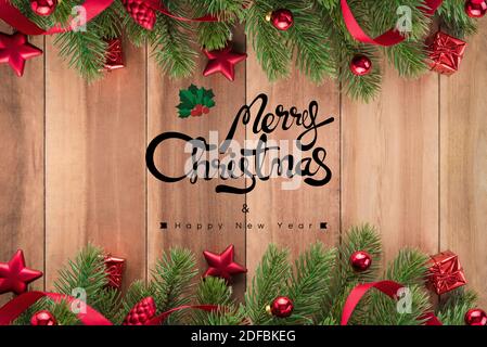 Merry Christmas and Happy New Year text on wood background with Christmas ornament borders Stock Photo