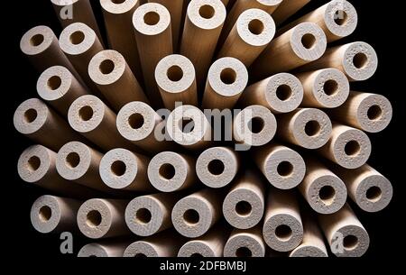 Wooden flower from turned legs, concept. Turned wooden legs folded like a flower isolated on black background Stock Photo