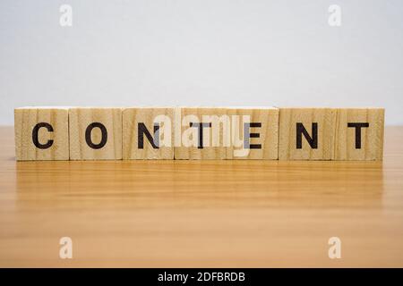 Wooden block on desk with the word Content. Stock Photo