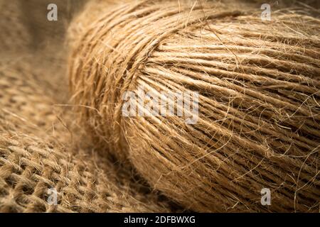 Close up wrapped linen rope isolated on burlap Stock Photo