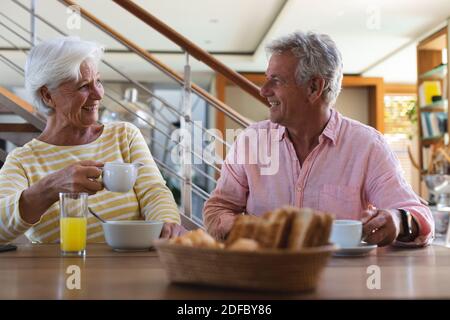 Happy senior caucasian couple having breakfast at home Stock Photo