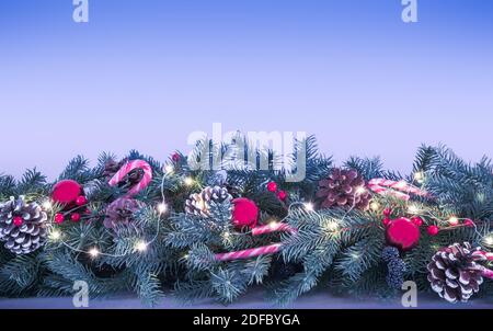 Garland with Christmas decorations on blue background. Stock Photo