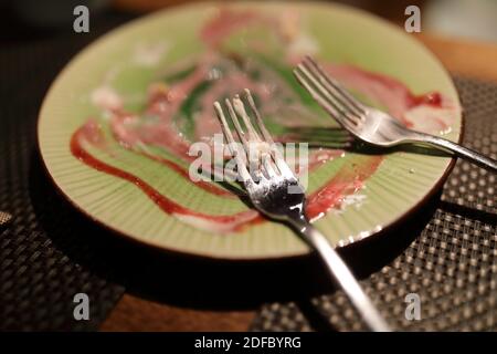 Leftover dessert on a plate in restaurant Stock Photo