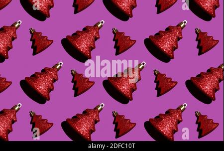 Seamless Christmas pattern. Red Christmas toy on a purple background. Wrapping. Stock Photo