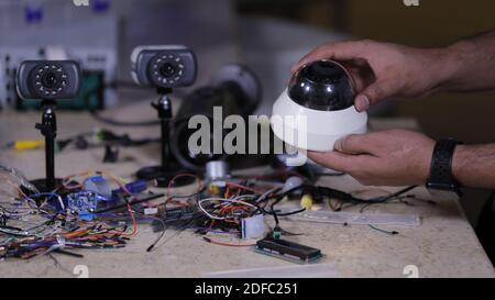 A man repairing CCTV camera in the service center Stock Photo