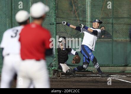 Yumiko Suzuki, right, wife of Seattle Mariners' Ichiro Suzuki and an  unidentified person, left, smile and cheer as they look on following  Ichiro's 200th hit in the second baseball game of a