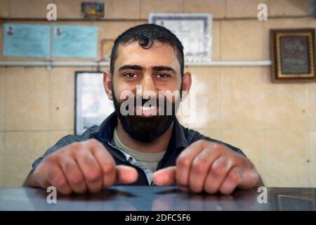 Iran, portrait of handsome smiling Iranian man with beard in Yazd Stock Photo