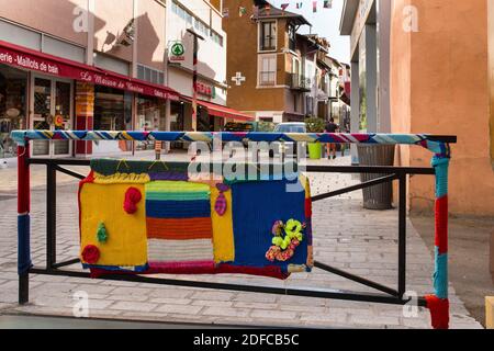 France, Hautes Alpes, Gap, rue Jean Eymar and barriere covered with knitted pieces Stock Photo