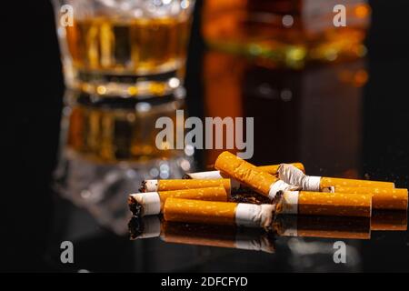 Cigarette butts on black background close up Stock Photo