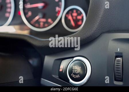 GRODNO, BELARUS - JUNE 2020: BMW X3 II F25 xDrive Selective focus on red enlightened Car Start Stop Engine Button. Element of interior inside car with Stock Photo