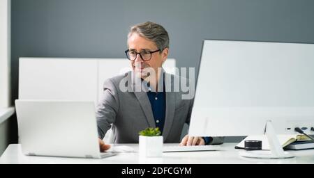 Happy Professional Man Employee Using Computer For Work Stock Photo
