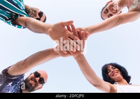 group of friends putting their hands together. people stacking their hands together friendship, teamwork and cooperation concept Stock Photo