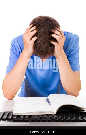 Sad Young Man with a Book and a Computer Keyboard on the White Background Stock Photo