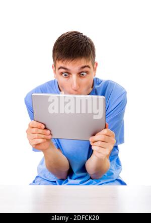 Surprised Young Man with a Tablet Computer Isolated on the White Background Stock Photo