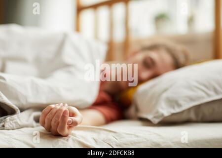 Close-up of young woman lying on bed and sleeping at home Stock Photo
